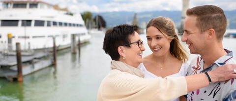 Mutter mit Tochter und Schwiegersohn im Hafen in Lindau.