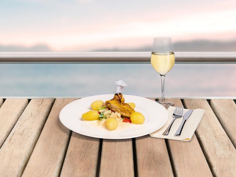 Bei einer Bodensee Schifffahrt Hähnchen mit einem Weißwein und den Ausblick genießen.